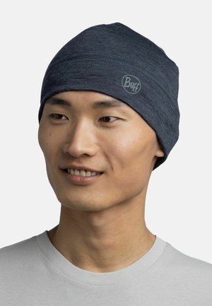 Dark blue knit beanie with a snug fit, made of soft fabric, featuring a subtle logo and even stitching across the top.
