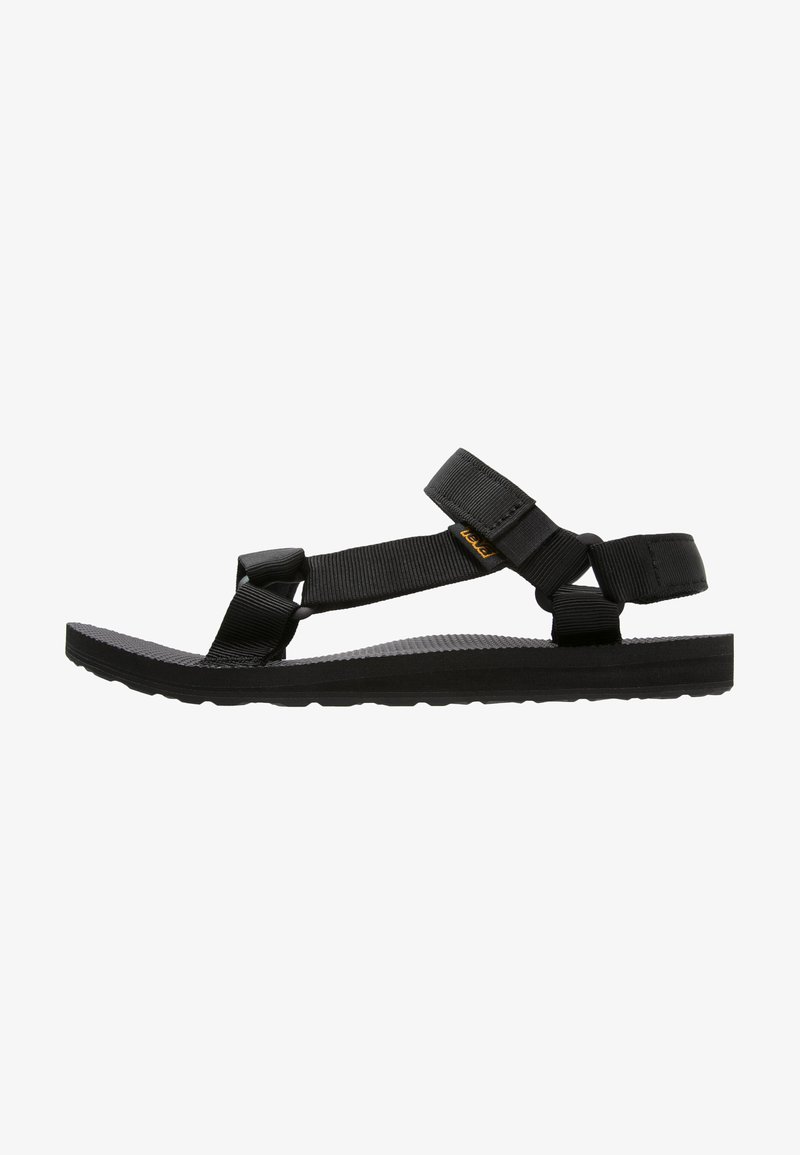 Black sandal featuring adjustable nylon straps and a textured rubber sole. Design prioritizes comfort, suitable for casual outdoor wear.
