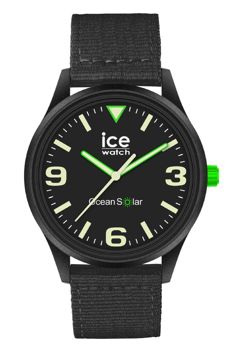 Black analog watch with a textured strap, bold white numerals, luminous green hands and accents, and a black dial featuring "Ocean Solar."