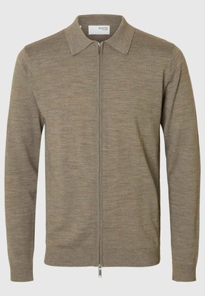 Beige knit zip-up sweater with a collared neckline, long sleeves, and subtle texture. Features a straight hem and silver zipper detail.