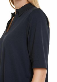 Námořnická krátko-rukávová blůza s límečkem, s mírným výstřihem do V a hladkým, lehkým materiálem. Elastický a pohodlný střih.