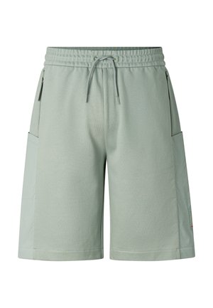 Hellgrüne knielange Shorts mit elastischem Bund, Kordelzug und seitlichen Reißverschlusstaschen auf weißem einfarbigem Hintergrund.