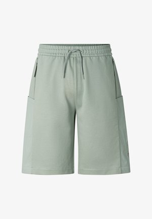 Shorts vert clair mi-genoux avec ceinture élastique, cordon de serrage et poches latérales zippées sur fond blanc uni.