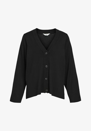 Melnā džempera ar V veida izgriezumu, garām piedurknēm un pieciem melniem pogām priekšpusē. Izgatavots no mīksta materiāla ar smalku struktūru.