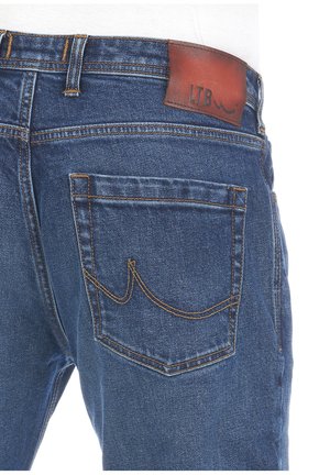 Denim jeans in medium blue with visible stitching details. Features a brown leather patch labeled "LTB" and two back pockets.