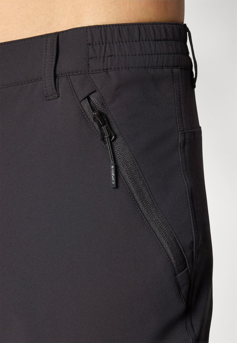 Schwarze Sportshorts mit elastischem Bund, seitlichem Reißverschlusstasche und glattem, leichtem Stoff in figurbetonendem Schnitt.