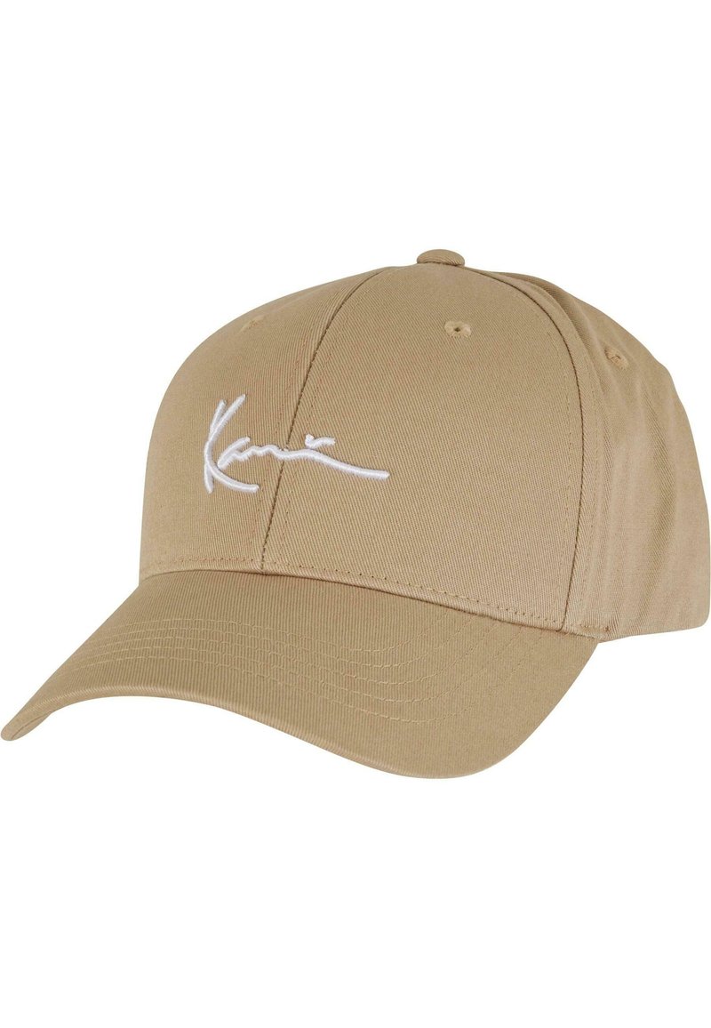 Beige baseball cap made of cotton blend fabric with a curved visor, featuring white embroidered logo on the front and ventilation holes.