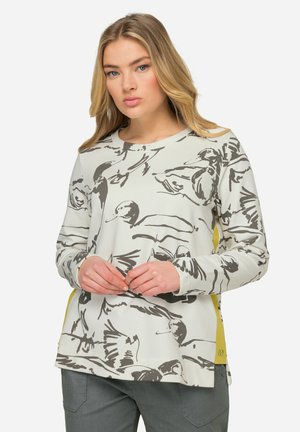 Sweatshirt gris clair avec un imprimé d'oiseau noir, col rond, manches longues et accents jaunes sur les côtés, fabriqué en tissu doux.