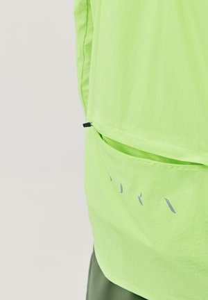 Neon green lightweight fabric top with a back pocket. Features a straight cut and minimalistic design with subtle gray accents.