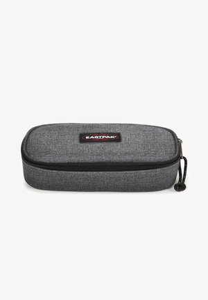 Trousse en tissu gris de forme rectangulaire arrondie, avec fermeture éclair et un patch logo Eastpak bien visible à l'avant.