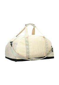 Sac de sport beige avec un fond noir, doté de poignées renforcées et d'une bandoulière amovible, fabriqué à partir de matériaux durables avec une texture lisse.