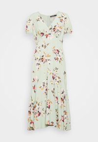 Ljusgrön midiklänning med rosa, gula och bruna blommönster, V-ringning, korta puffärmar och utsvängd kjol.