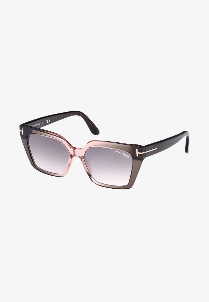 Tom Ford Sonnenbrille mit übergroßen hexagonalen Fassungen, grauen Verlaufslinsen und einem schwarz-rosa Farbverlauf. Goldene Akzente an den Bügeln.