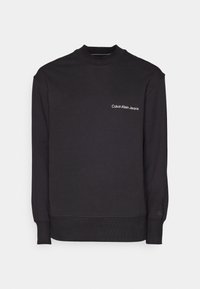 Felpa nera in misto cotone, con scollatura a girocollo, polsini a coste e un piccolo logo bianco "Calvin Klein Jeans" sul petto.