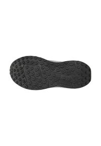 Semelle de chaussure en caoutchouc noir avec surface texturée présentant des motifs hexagonaux et rectangulaires pour une meilleure traction. Design de bout et de talon arrondi.