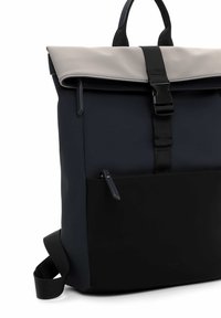 Zaino con corpo blu scuro, pattina grigia, spallacci neri regolabili e una tasca frontale con cerniera. Realizzato in tessuto testurizzato con un design elegante.