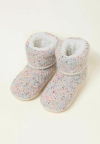 Gestrickte Hausschuhe in hellgrau mit bunten Sprenkeln. Flauschiges weißes Futter und Bündchen, mit einer glatten, abgerundeten Zehenpartie und strukturiertem Körper.