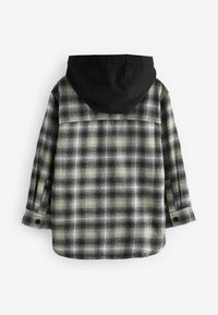 Chemise à manches longues à carreaux noirs et gris avec poignets boutonnés et capuche unie noire attachée, vue de dos sur fond blanc.