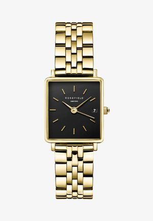 Gold rectangular watch with a black face, gold hour markers, and date window. Metal bracelet features flat, shiny links and a clasp.