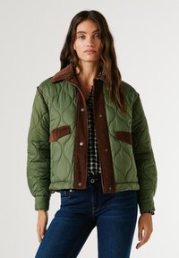 Quilted green jacket with brown corduroy collar and pockets, featuring silver snaps, designed with a padded texture and structured fit.