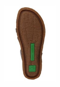 Brown rubber sole with a textured surface, featuring a green label that reads "Recyclus" and another with a frog logo; durable design.