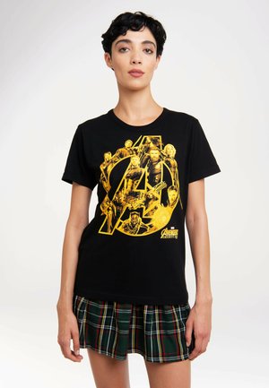 Black cotton t-shirt featuring a bold yellow graphic of superhero characters within an Avengers logo, with a round neckline and short sleeves.