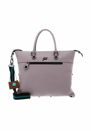 Sac à main en cuir rose doux avec doubles poignées, poche zippée à l'avant, bandoulière amovible noire et turquoise rayée, et une petite étiquette brune attachée.