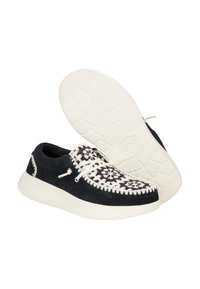Scarpe casual con una parte superiore in suede nero e dettagli in pizzo bianco, e una suola in gomma bianca testurizzata.