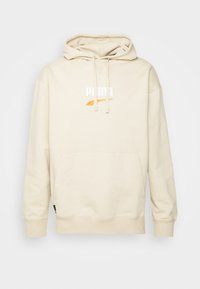 Sweat à capuche beige avec poche avant, cordons de serrage, et logo Puma blanc et orange centré sur la poitrine.