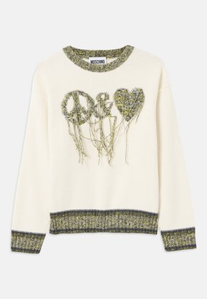 Krems svītra ar uzrakstu "mieru" un sirds dizainu tekstūrētā zaļā dzijā. Iezīmējas ar ribotu apkakli un aprocēm, kas papildinātas ar kontrastējošām tumšām акcentu.