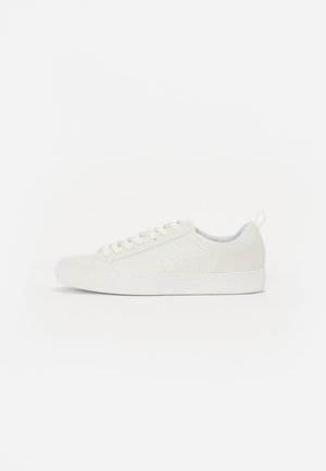White sneaker with textured surface featuring a geometric pattern. Rounded toe, white laces, and a low-profile sole.