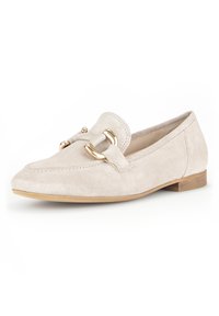 Beige suede loafers with a gold-tone buckle accent and a flat wooden sole. Features a pointed toe and stitched detailing along the edge.