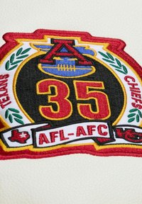 Embroidered patch with red "35," blue football, "AFL-AFC," and "Texans Chiefs" text with decorative green leaves on white fabric.