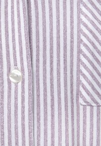 Striped fabric with alternating white and maroon lines. Features a round, pearlescent button and a pocket with a diagonal stripe design.