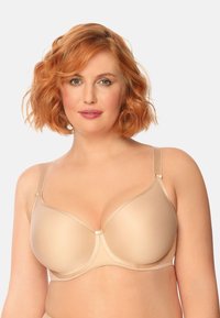 Beżowy biustonosz z formowanymi miseczkami, z regulowanymi ramiączkami, wsparciem drucianym i gładką fakturą. Posiada subtelny połysk i minimalne akcenty z hardware'u.