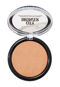 Bronzer compatto rotondo con una polvere marrone chiaro testurizzata, custodito in un case di plastica trasparente con una base nera e un coperchio riflettente.