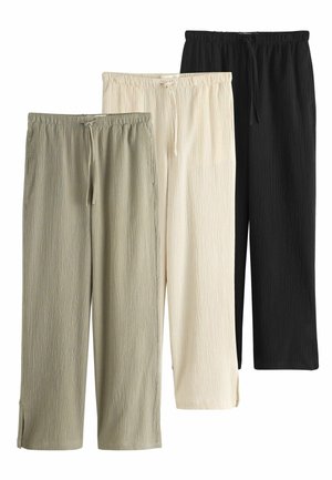 Drei Paare locker sitzender Hosen aus strukturiertem Stoff in Olivgrün, Off-White und Schwarz mit elastischen Bündchen und Kordelzügen.