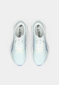 Chaussures de sport bleu clair avec une tige texturée, des lacets blancs et des accents bleus. Comprennent un logo et des trous d'aération.