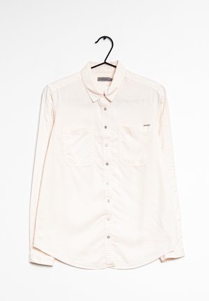 Lichtbeige overhemd met lange mouwen en knopen, gemaakt van gladde stof. Voorzien van twee borstzakken en een subtiel logolabel aan de linkerkant.