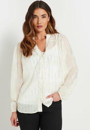 White button-up blouse with sheer, textured fabric and vertical metallic stripes. Features long sleeves and a relaxed fit.