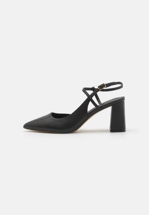Black pointed-toe slingback heels with a smooth leather finish, block heel, and adjustable ankle strap featuring gold-tone hardware.