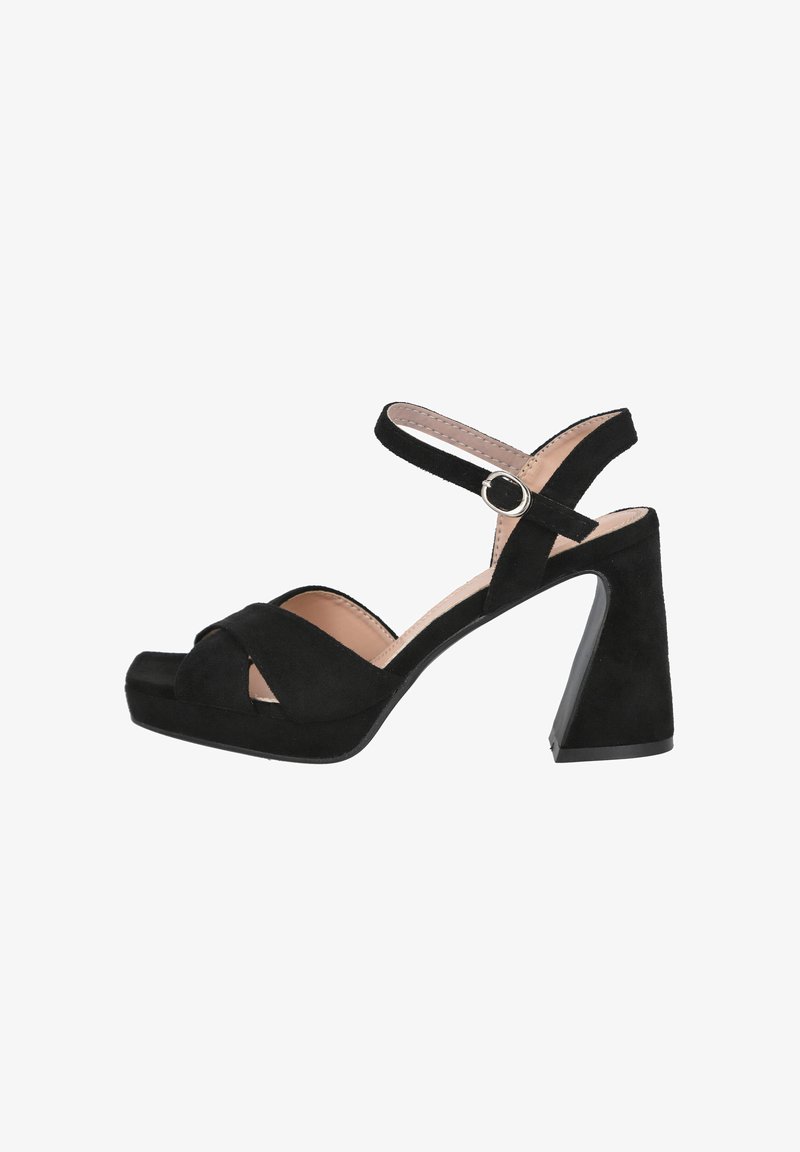 Sandalias de tacón alto de ante negro con correas cruzadas, puntera abierta, correa en el tobillo y un tacón grueso. Textura suave, diseño minimalista.