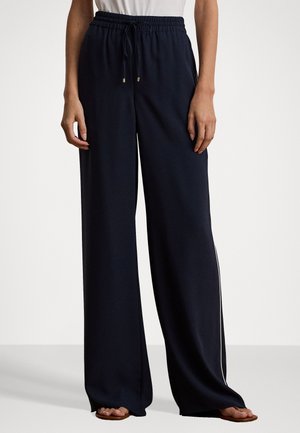 Navy wide-leg pants with an elastic waistband and drawstring. Features gold accents and a white side stripe for contrast. Smooth fabric texture.