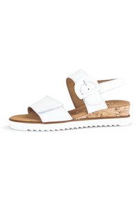 Sandali wedge bianchi con due cinturini regolabili, tacco con texture in sughero, materiale in similpelle liscia e suola in gomma con bordo seghettato.