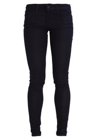 Jeans ajustados de mezclilla oscura. Cintura alta, cinco bolsillos y un cierre clásico de botón. Textura suave con ligero estiramiento.