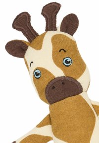 Ruskea ja kermanvärinen neulottu kirahvipehmo, jossa on siniset silmät, pienet ruskeat sarvet ja raidoitettu kuvio raajoissa. Pehmeä tekstuuri, nivelletysti muotoiltu.