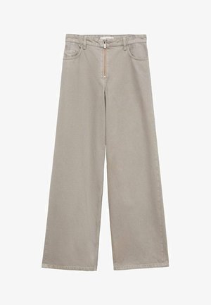 Beżowe spodnie o szerokich nogawkach, wykonane z materiału o gładkiej fakturze. Posiadają zamek błyskawiczny, szlufki na pasek oraz kieszenie z przodu.