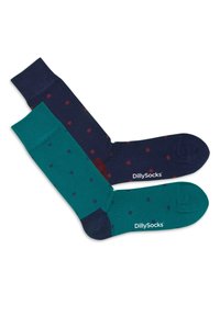 Deux paires de chaussettes : l'une bleue marine avec des pois rouges, l'autre bleu sarcelle avec des pois navy. Les deux présentent des bords côtelés et des logos au niveau de la cheville.
