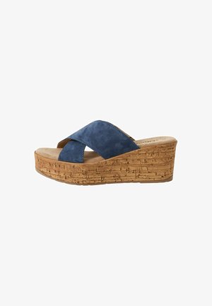 Sandales à plateforme en suède bleu avec un talon en liège. Des brides croisées et une semelle texturée améliorent l'adhérence et le confort.