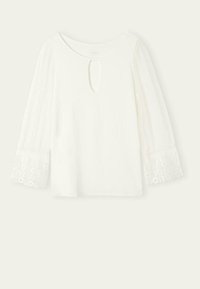 Top bianco con scollatura rotonda, dettaglio a buco chiave e maniche lunghe in voile trasparente con ricamo floreale ai polsini. Tessuto dalla consistenza liscia.